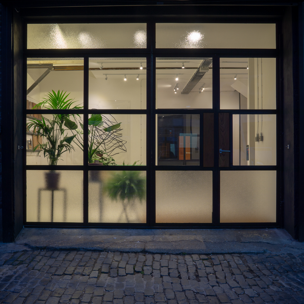 ENTRANCE, Bespoke mild steel doors with Iroko inlay panels. Georgian wire glass.
