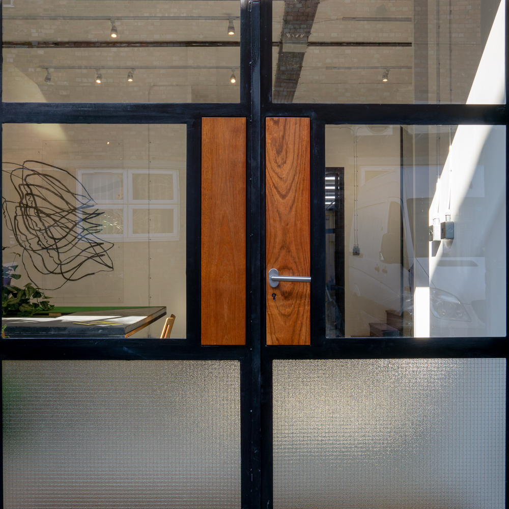FRONT DOOR, Bespoke mild steel doors with Iroko inlay panels. Georgian wire glass.
