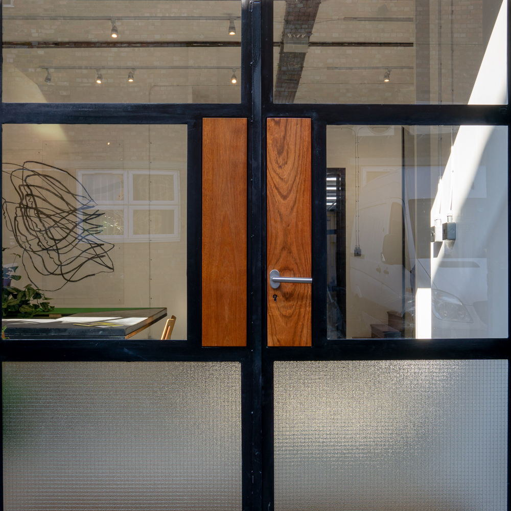 FRONT DOOR, Bespoke mild steel doors with Iroko inlay panels. Georgian wire glass.
