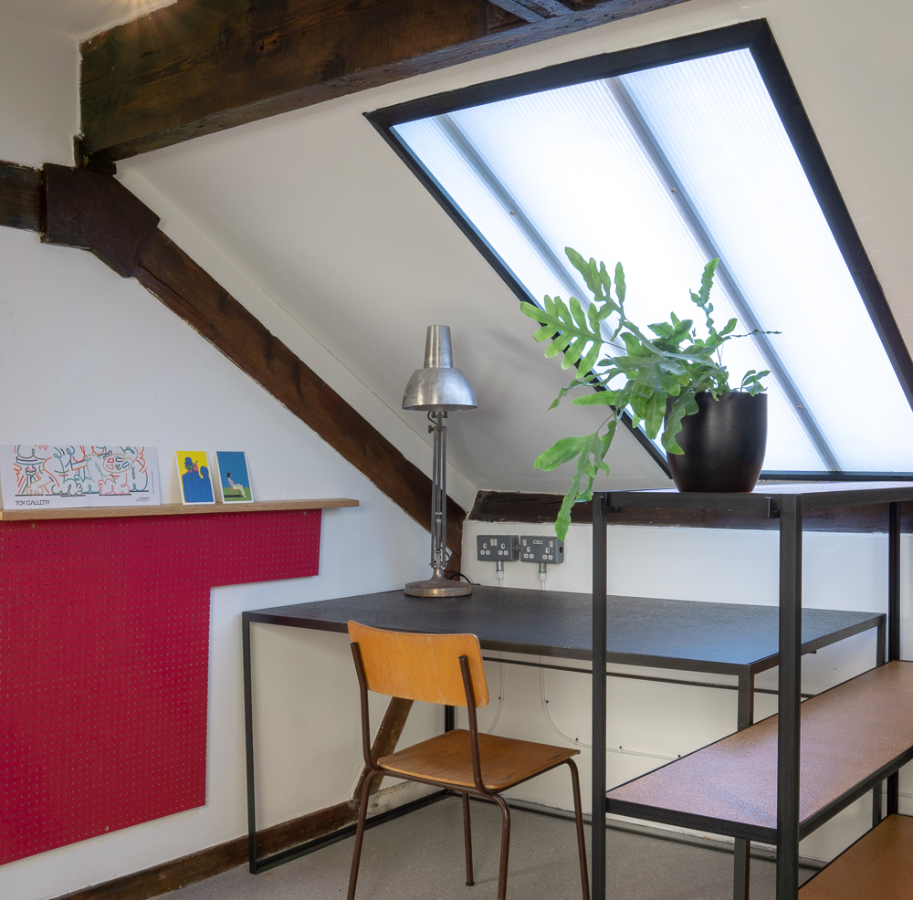 Desk Space, Mild steel desk with blackened cork top. Mild steel shelving unit with varnished cork shelves.
