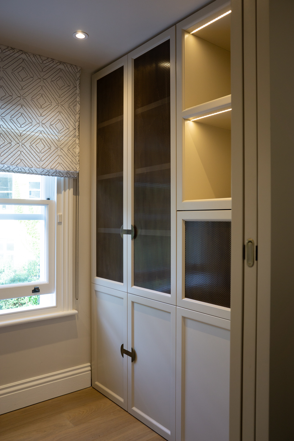 Office Right, More cabinets with antique punch brass mesh. View of pocket door recess, very tightly engineered. 
