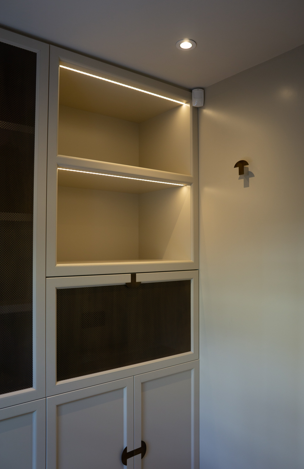 Display Cabinets, With integrated lighting. We also used our custom handle design as a coat hook on the reverse side of the pocket door housing.
