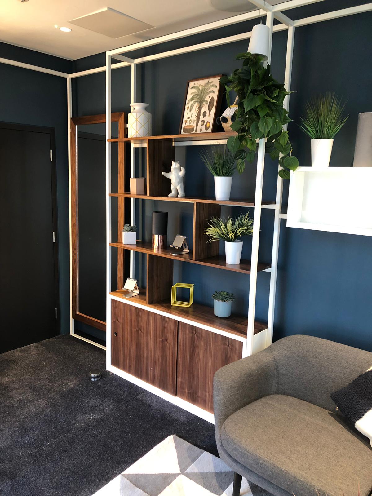 Green room, Walnut cabinet and shelving with sliding doors. Full length walnut mirror.
