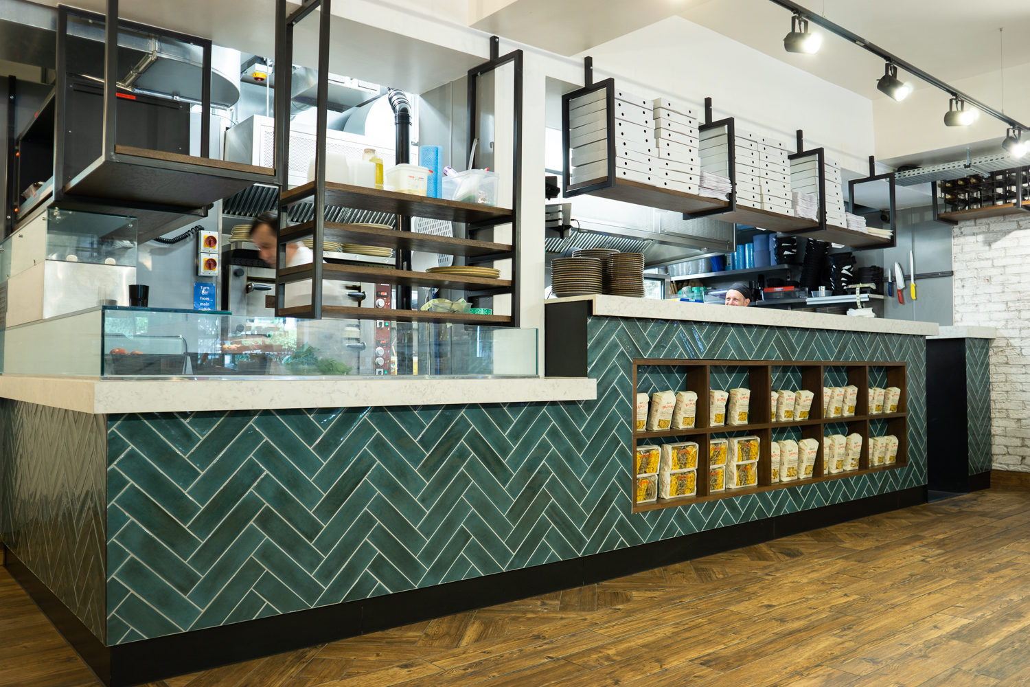 Kitchen Pass, Formica Aria worktops. Integrated shelving. Gantries with stained oak shelves. 
