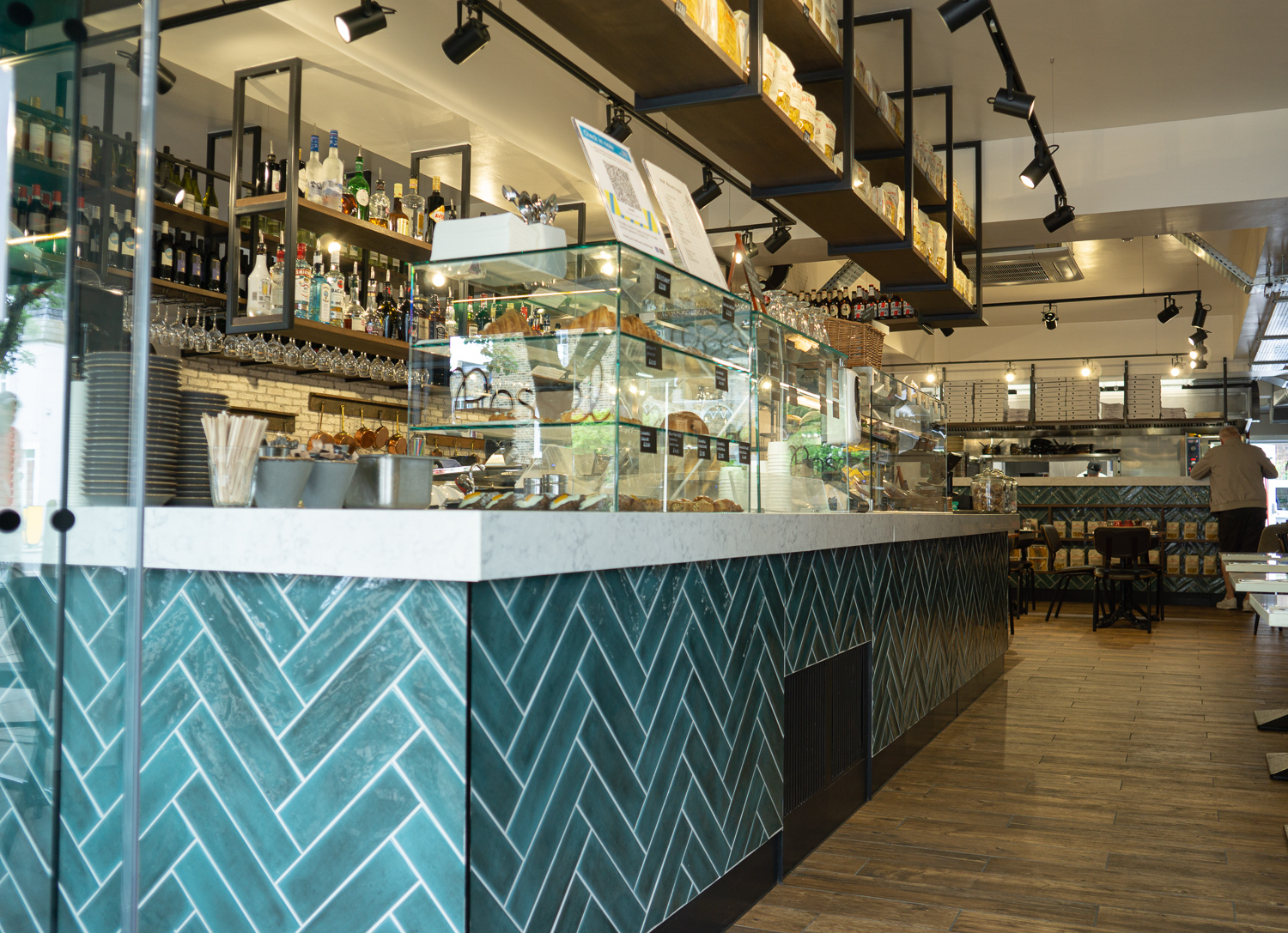 Deli Bar, Formica Aria worktops with drop edge. Bar frame, skirting and kick rail all powder coated mild steel. Gantries with stained oak shelves. 
