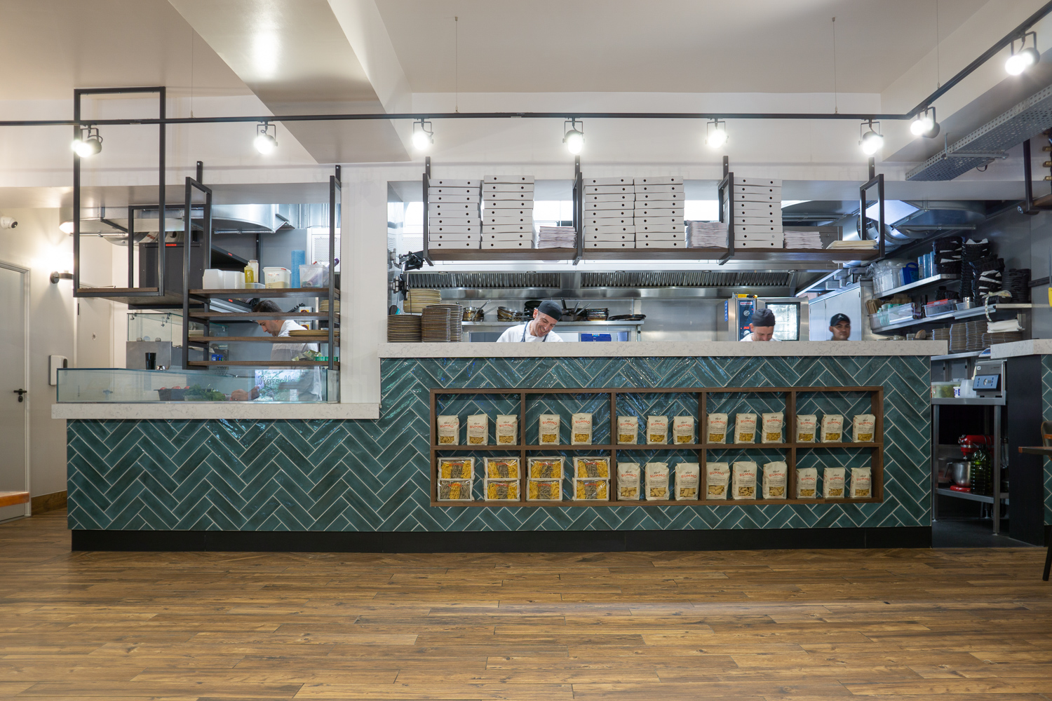 Kitchen Pass, Formica Aria worktops. Integrated shelving. Gantries with stained oak shelves. 