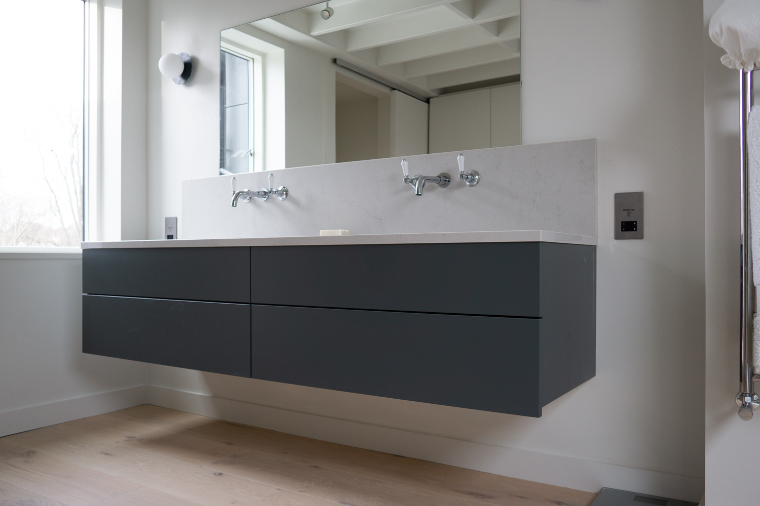 TENNYSON ROAD, Cesar Stone vanity mounted as floating countertop all drawers functional around plumbing
