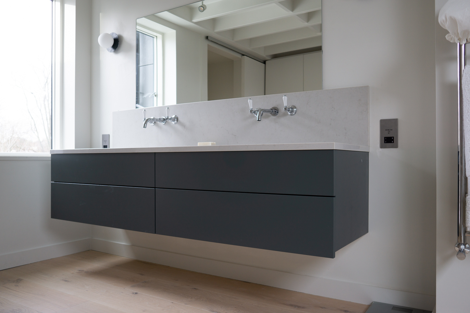 TENNYSON ROAD, Cesar Stone vanity mounted as floating countertop all drawers functional around plumbing
