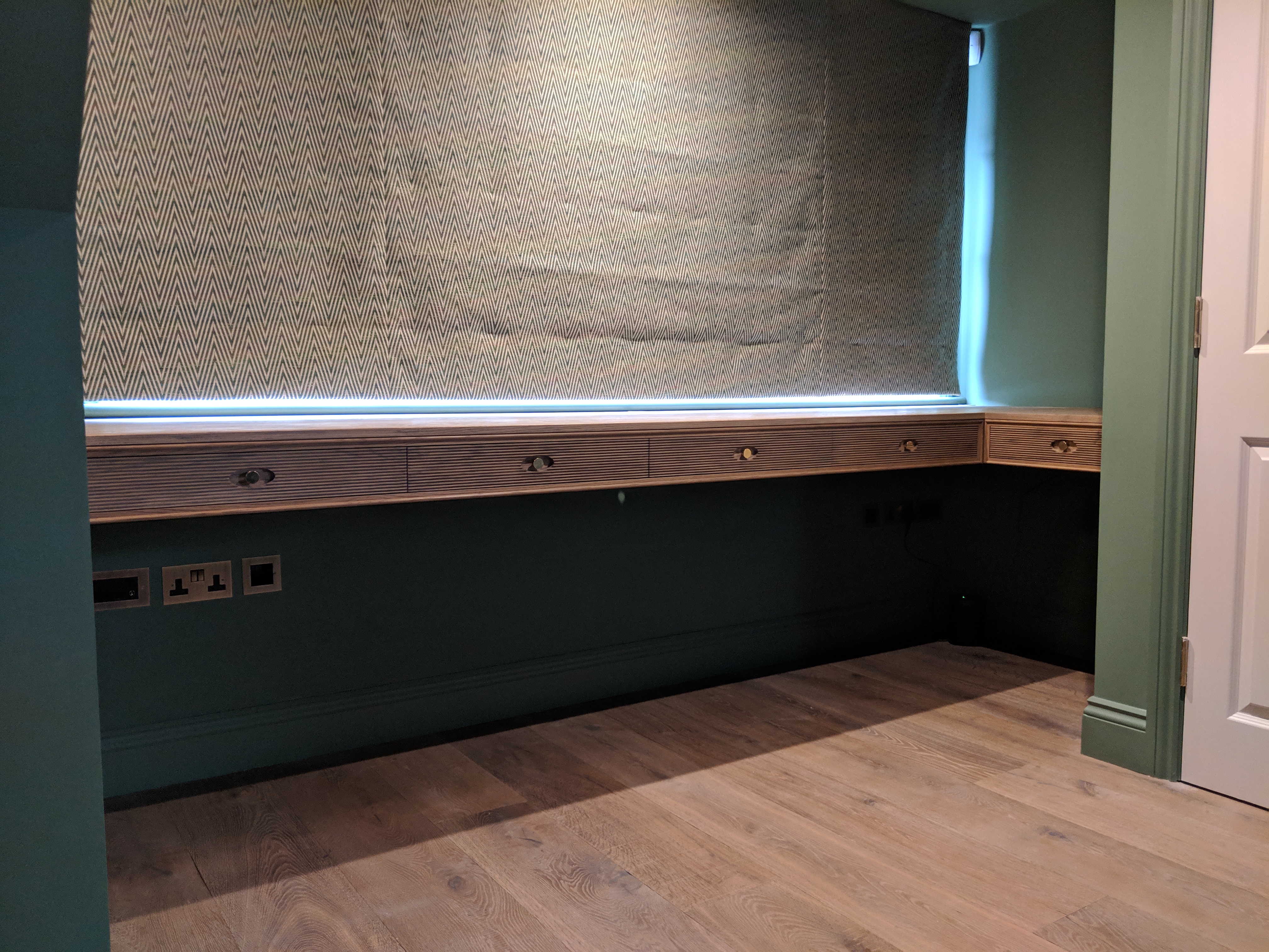 CORNER DESK, Brined oak with reeded drawer fronts.
